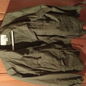 Green jacket missing a button on left wrist